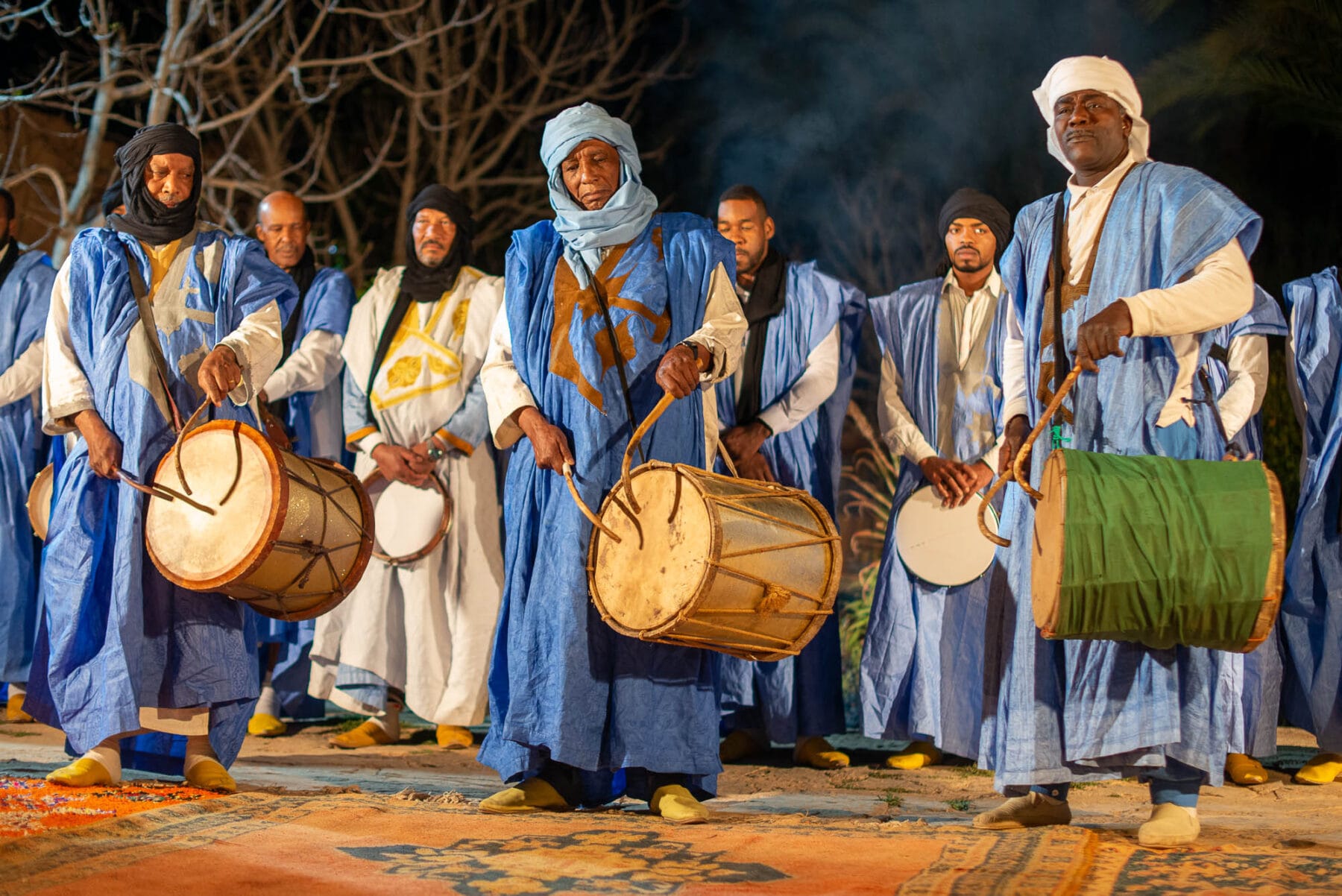 Traditional musicians in blue attire.